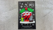 Vibrant fireplace ornament with holly and presents, displaying 5 red stockings, shown on backing card and Christmas tree.