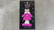 Pink princess with crown and black hair ornament, shown on backing card and Christmas tree.