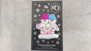 Family ornament with 2 large and 2 infant snowmen in pink, shown on backing card and Christmas tree.