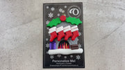 Vibrant fireplace ornament with holly and presents, displaying 8 red stockings, shown on backing card and Christmas tree.