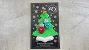 Christmas tree ornament decorated with 2 light bulbs with smiling faces, shown on backing card and decorated Christmas tree.