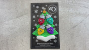 Christmas tree ornament decorated with 4 light bulbs with smiling faces, shown on backing card and decorated Christmas tree.