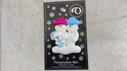 Family ornament with 2 large and 1 infant snowman in blue, shown on backing card and Christmas tree.