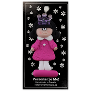Pink princess with crown and black hair ornament. on display backing card.
