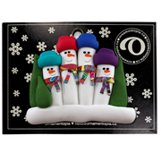 Family ornament with 4 snowmen in colourful scarves and hats, hemmed by Christmas trees, on display backing card.