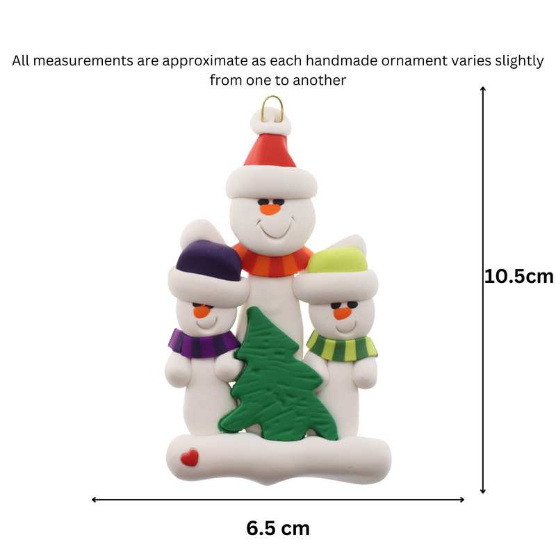 Family ornament with 1 large and 2 small white snowmen in bright scarves, with green Christmas tree, graphed to show size (6.5x10.5cm).