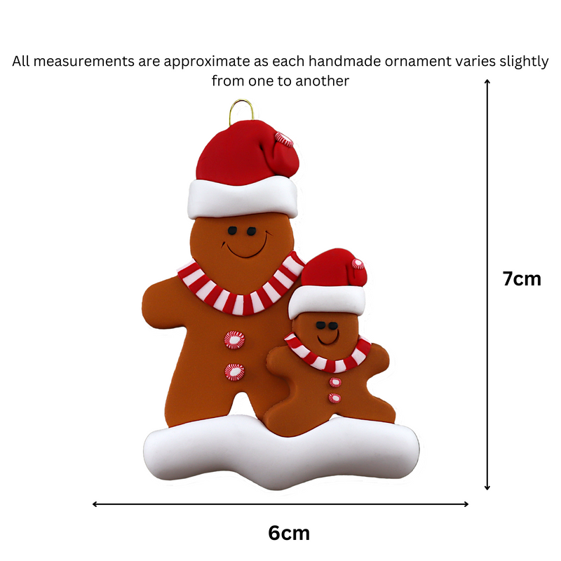 Family ornament with 1 large and 1 small brown gingerbread figure in red Christmas hats, graphed to show size (7x9.5cm).