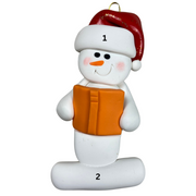 Ornament of white snowman in red hat holding an orange book, numbered 1-2 for personalization.