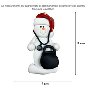 Ornament of white snowman in red hat holding a stethoscope and black medical bag, graphed to show size (4x9cm).