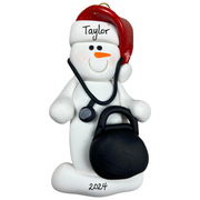 Ornament of white snowman in red hat holding a stethoscope and black medical bag, personalized with name.