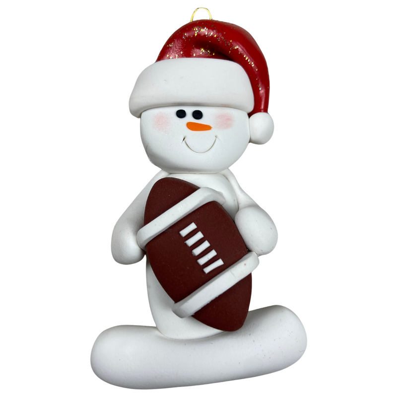 Ornament of white snowman in red hat holding a football.
