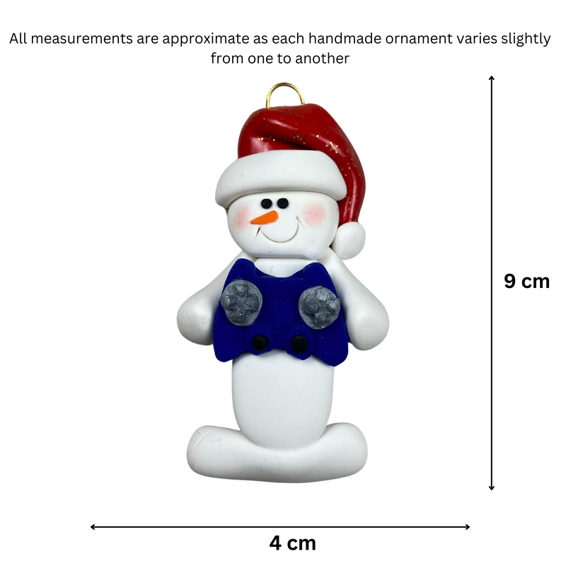 Ornament of white snowman in red hat holding a blue video game controller, graphed to show size (4x9cm).