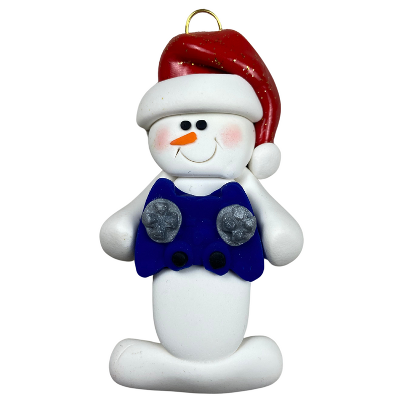 Ornament of white snowman in red hat holding a blue video game controller.