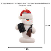 Ornament of white snowman in red hat holding a hunting rifle and pair of binoculars, graphed to show size (4x9cm).