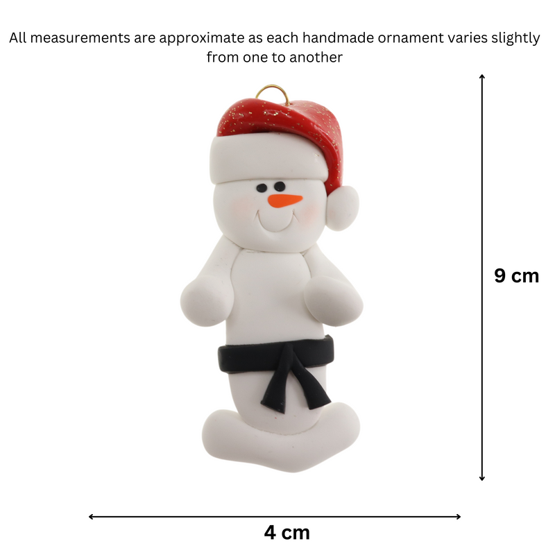 Ornament of white snowman in red hat wearing black belt, graphed to show size (4x9cm).