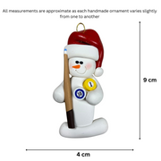 Ornament of white snowman in red hat holding a pool cue and pool balls, graphed to show size (4x9cm).