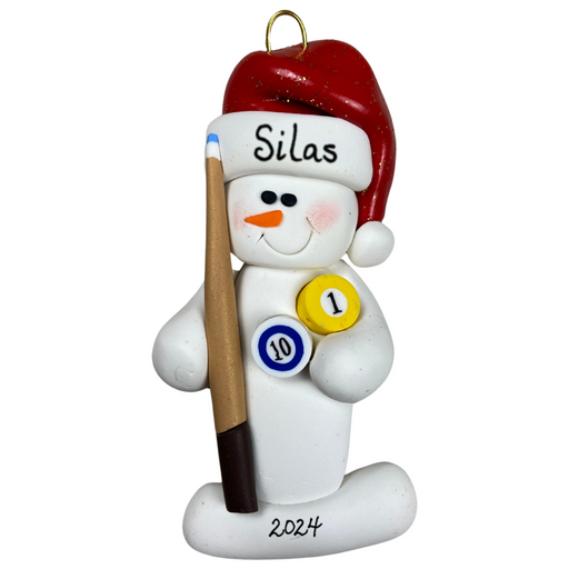 Ornament of white snowman in red hat holding a pool cue and pool balls, personalized with name.