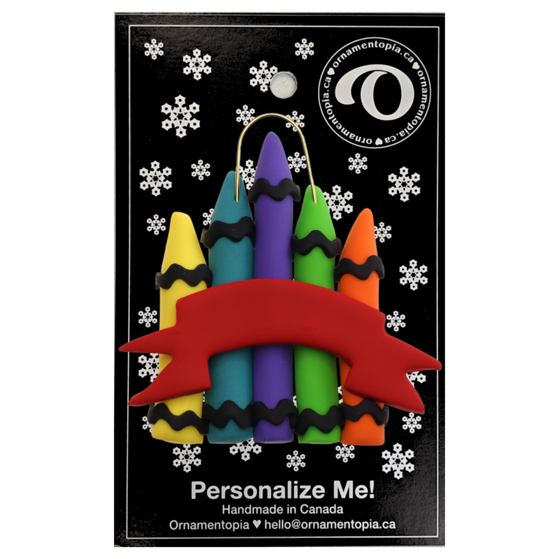 Stack of crayons joined with red ribbon teacher appreciation ornament, on display backing card.