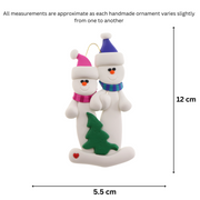 Family ornament with 2 white snowmen in bright scarves, with green Christmas tree, graphed to show size (5.5x12cm).