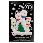 Family ornament with 4 white snowmen in bright scarves, with green Christmas tree, on display card backing.