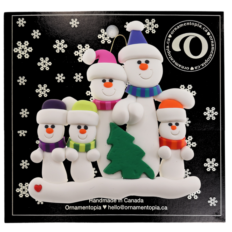 Family ornament with 5 white snowmen in bright scarves, with green Christmas tree, on display card backing.