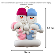Family ornament with 2 large and 2 infant snowmen in pink and blue, graphed to show size (9x9.5cm).