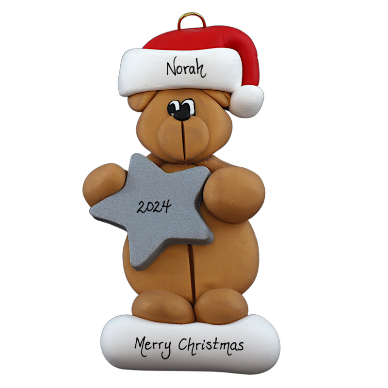 Tan bear in red festive hat holding silver star ornament, personalized with name.
