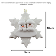 Family ornament with 2 white snowmen stacked on top of a glitter white snowflake, graphed to show size (9x10cm).