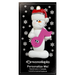 Ornament of white snowman in red hat holding a pink music note, on display backing card.