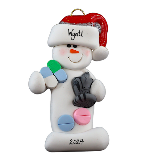 Ornament of white snowman in red hat holding various pills and a mortar and pestle, personalized with name.
