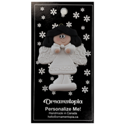 Angel wearing white with black hair ornament, on display backing card.