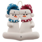 A couple’s ornament of two white snowmen in polka dot scarves and hats, numbered 1-3 for personalization.
