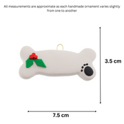 Ornament of dog bone with holly and paw print, graphed to show size (7.5x3.5cm).