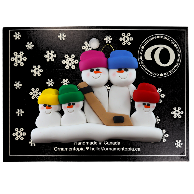 Family ornament with 5 white snowmen in bright hats, holding a hockey stick, on display backing card.