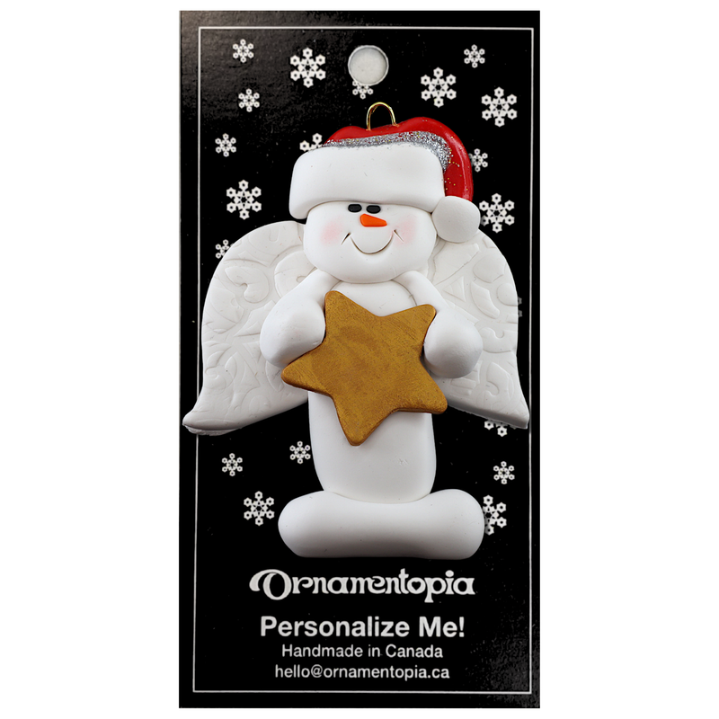 Ornament of white snowman in red hat with angel wings and a golden star, on display backing card.