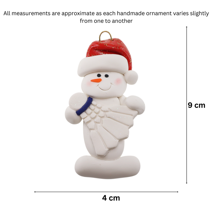 Ornament of white snowman in red hat holding a white badminton birdie, graphed to show size (4x9cm).
