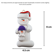 Ornament of white snowman in red hat holding smaller snowman, graphed to show size (4.5x9cm).