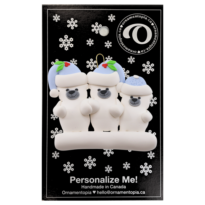 Family ornament with 3 polar bear figures in blue Christmas hats, on display backing card.
