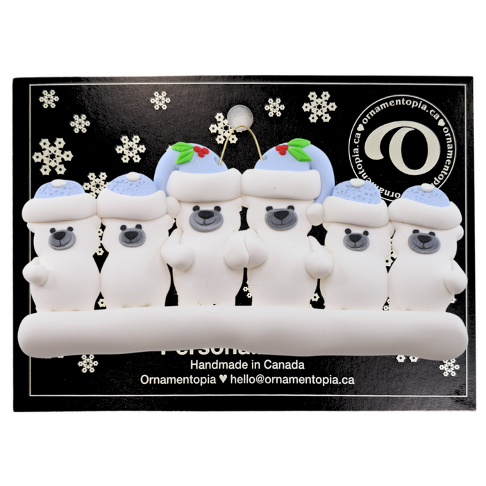 Family ornament with 6 polar bear figures in blue Christmas hats, on display backing card.