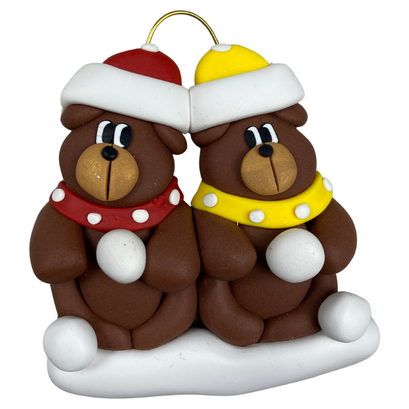 A couple’s ornament of two brown bears in polka dot scarves and hats.