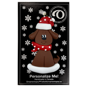 Ornament of brown dog in a red and white polka dot Christmas hat and scarf, on display backing card.