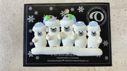 Family ornament with 5 polar bear figures in blue Christmas hats, shown on backing card and Christmas tree.