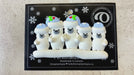Family ornament with 5 polar bear figures in blue Christmas hats, shown on backing card and Christmas tree.