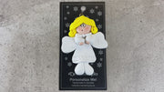 Angel wearing white with blonde hair ornament, shown on backing card and Christmas tree.