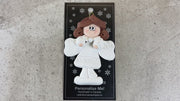 Angel wearing white with brown hair ornament, shown on backing card and Christmas tree.