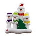 Family ornament with 1 large and 3 small white snowmen in bright scarves, with green Christmas tree.