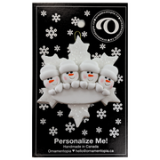 Family ornament with 4 white snowmen stacked on top of a glitter white snowflake, on display backing card.