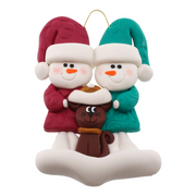 Ornament of snowman couple in red and green shirts and hats with a brown cat in Christmas hat.