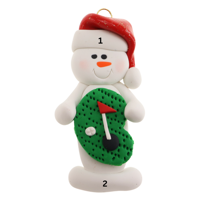 Ornament of white snowman in red hat holding a mini grass green with a golf ball and a flagstick, numbered 1-2 for personalization.