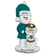 Ornament of snowman in a green shirt and hat with white cat in Christmas hat, personalized with names.